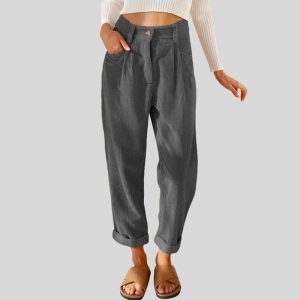 a person wearing a white top and grey pants